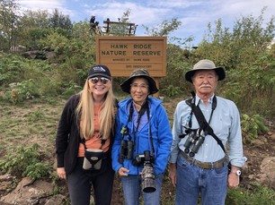 Hawk Ridge Executive Director Janelle Long with annual visitor friends from Japan